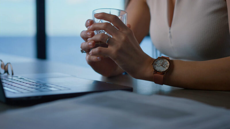 Woman wearing traditional wristwatch in the office