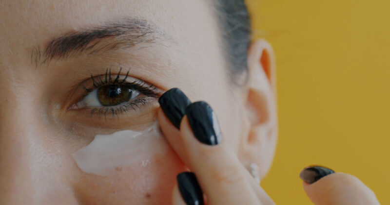 Applying eye cream in skincare routine