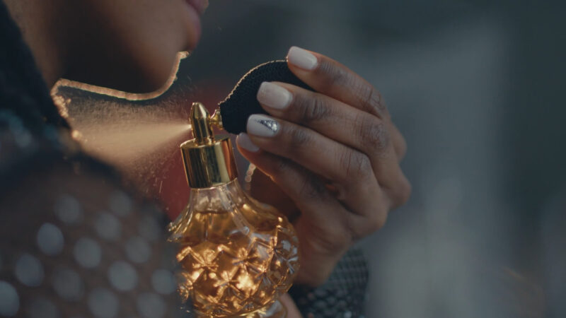 A girl testing perfumes on her skin